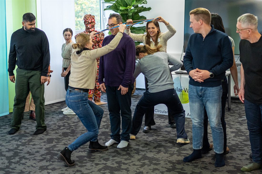 Menschen lösen eine Teamaufgabe mit Seilen